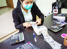 A difference between the official and unofficial exchange rate remains despite the Central Bank of Myanmar has brought its reference rate close to market's